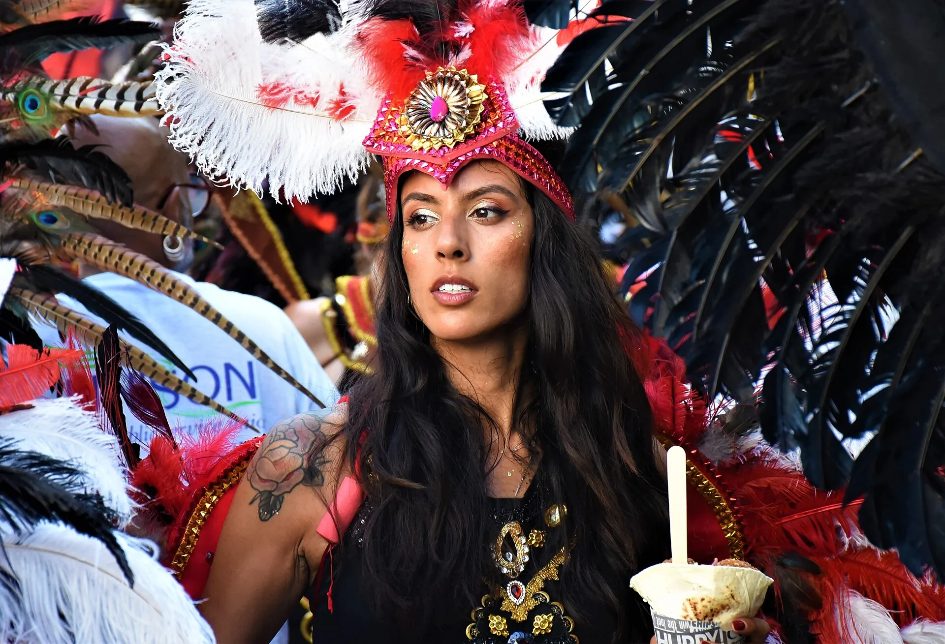 Masqueraders moving together on the Notting Hill Carnival parade route