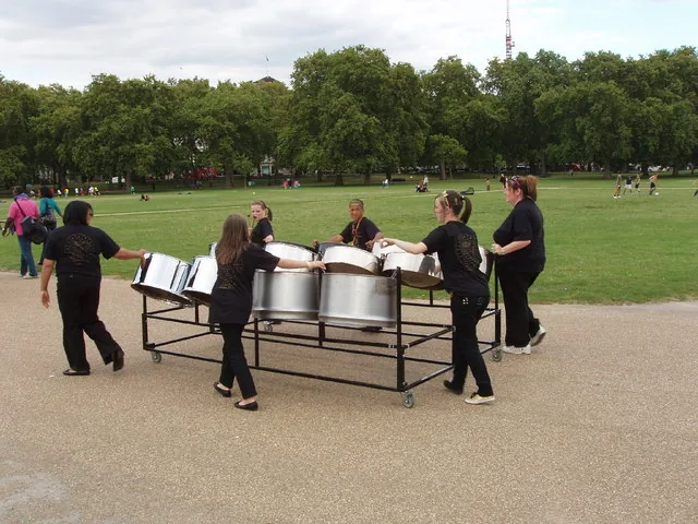 Women steelpan musicians wheeling their instruments towards the Panorama competition